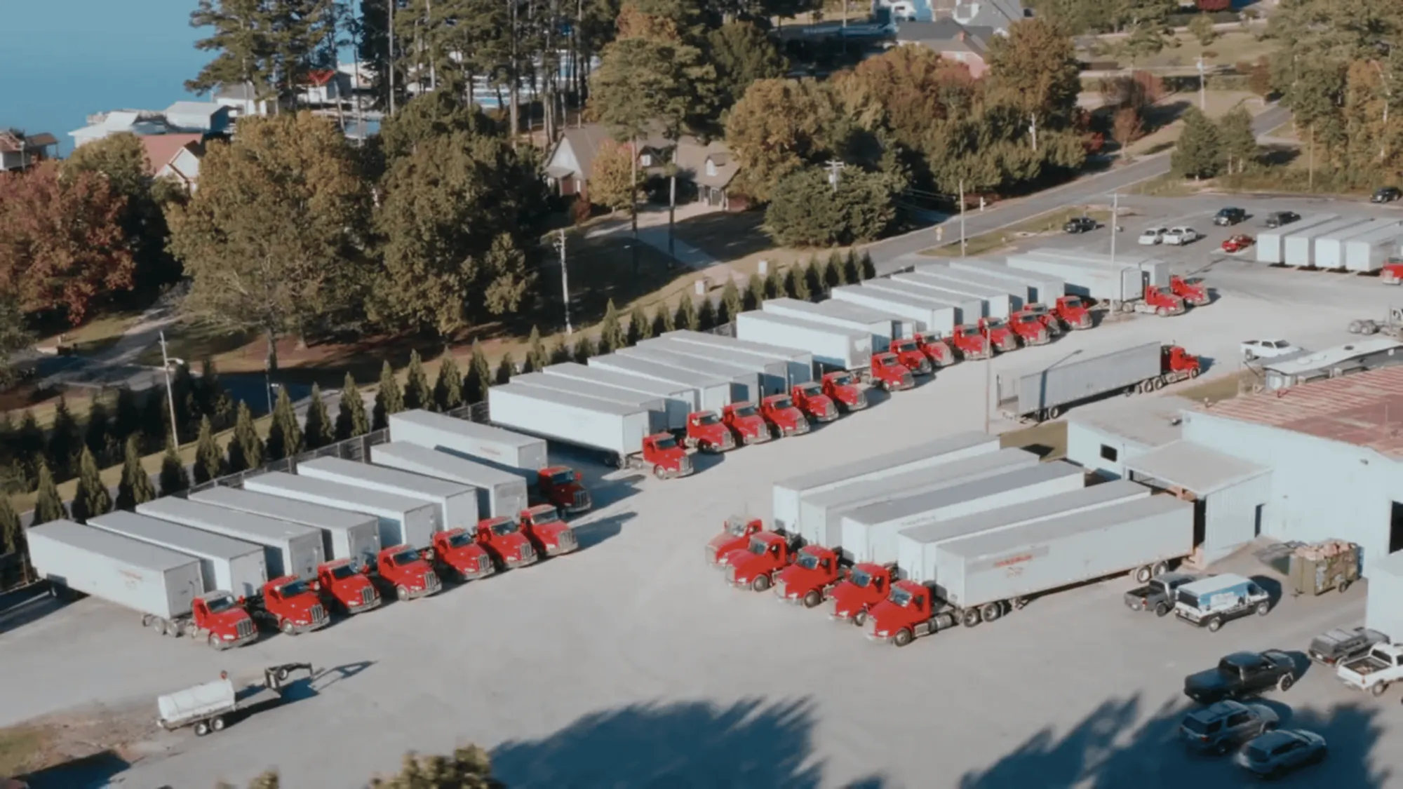 An aerial view of the TM Freight yard, its red-cab trucks lined up beside their trailers